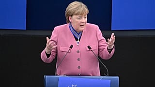 Former German Chancellor Angela Merkel delivers a speech after receiving the European Order of Merit