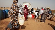 أشخاص يملأون حاويات المياه في نقطة توزيع مجانية وسط انقطاع المياه في الخرطوم، السودان، الاثنين 18 مايو 2026. (صورة AP/مروان علي)