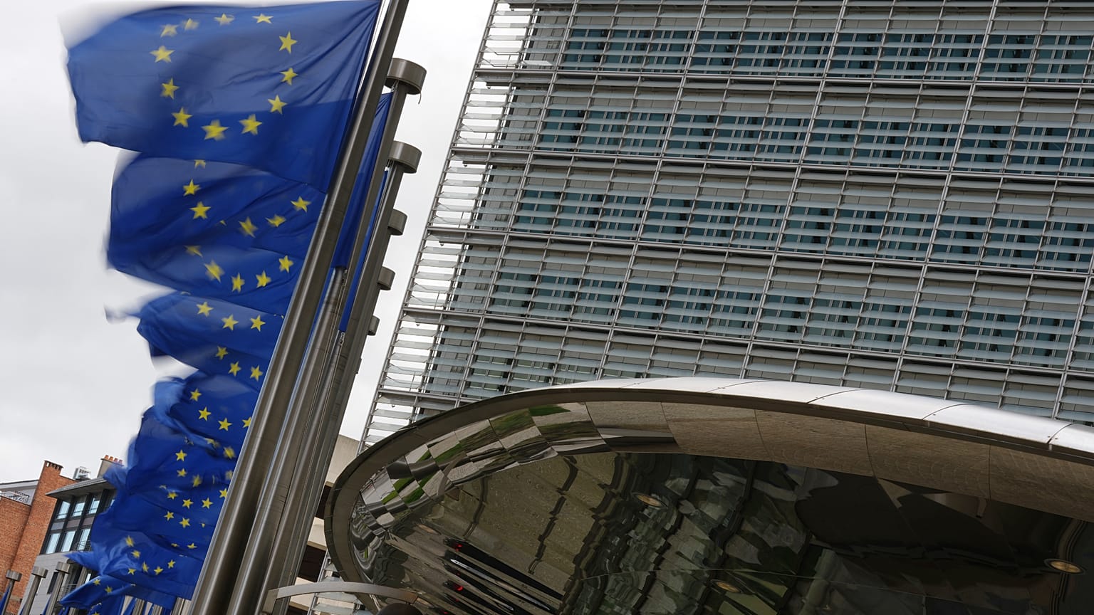 European Union flags flap in the wind outside EU headquarters in Brussels, Tuesday, May 12, 2026. (AP Photo/Virginia Mayo)