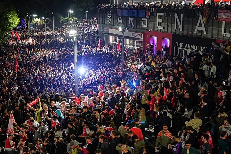 Arsenal supporters gather to celebrate at the Arsenal stadium after Arsenal's soccer team won the Premier League title in London, Tuesday, May 19, 2026