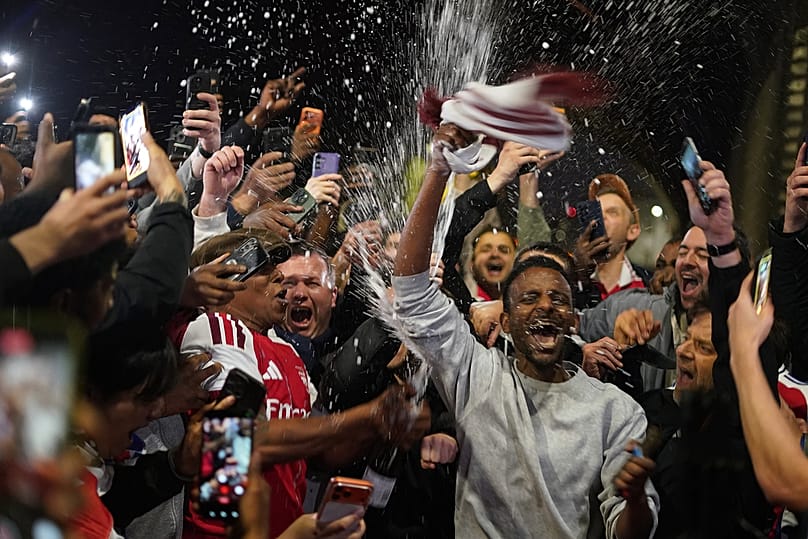 Arsenal supporters gather to celebrate at the Arsenal stadium after Arsenal's soccer team won the Premier League title in London, Tuesday, May 19, 2026