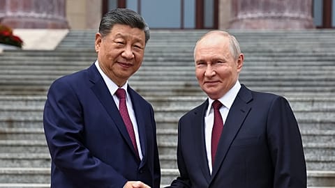 Russian President Vladimir Putin and Chinese President Xi Jinping shake hands in Beijing, China, Wednesday, May 20, 2026.