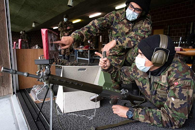 Soldiers of the Swiss army wear protective face masks during a rifle shooting exercise in the military compound of Chamblon near Yverdon-les-Bains, 30 April, 2020