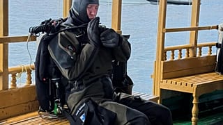 n this handout photo release by Maldives President Media Division, a Finnish diver gets ready to attempt to recover the bodies of two of the four Italians who died deep inside