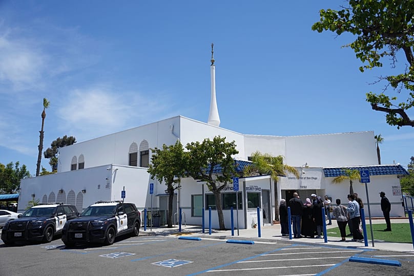 People gather as police vehicles are parked outside of the Islamic Centre of San Diego, 19 May, 2026