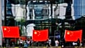 People show Chinese flags in front of the chancellery building in Berlin, 9 July, 2018