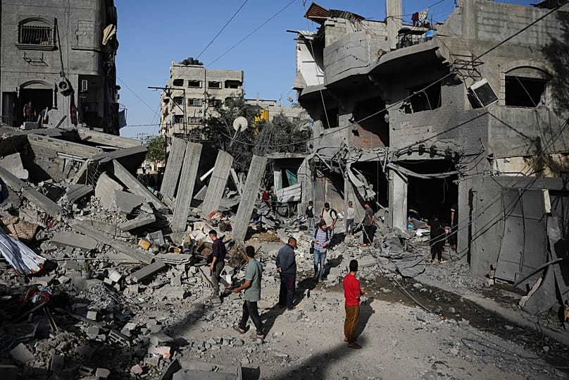 Palestinians inspect the rubble of a home destroyed in Israeli airstrike at the Bureij refugee camp in central Gaza, 20 May, 2026