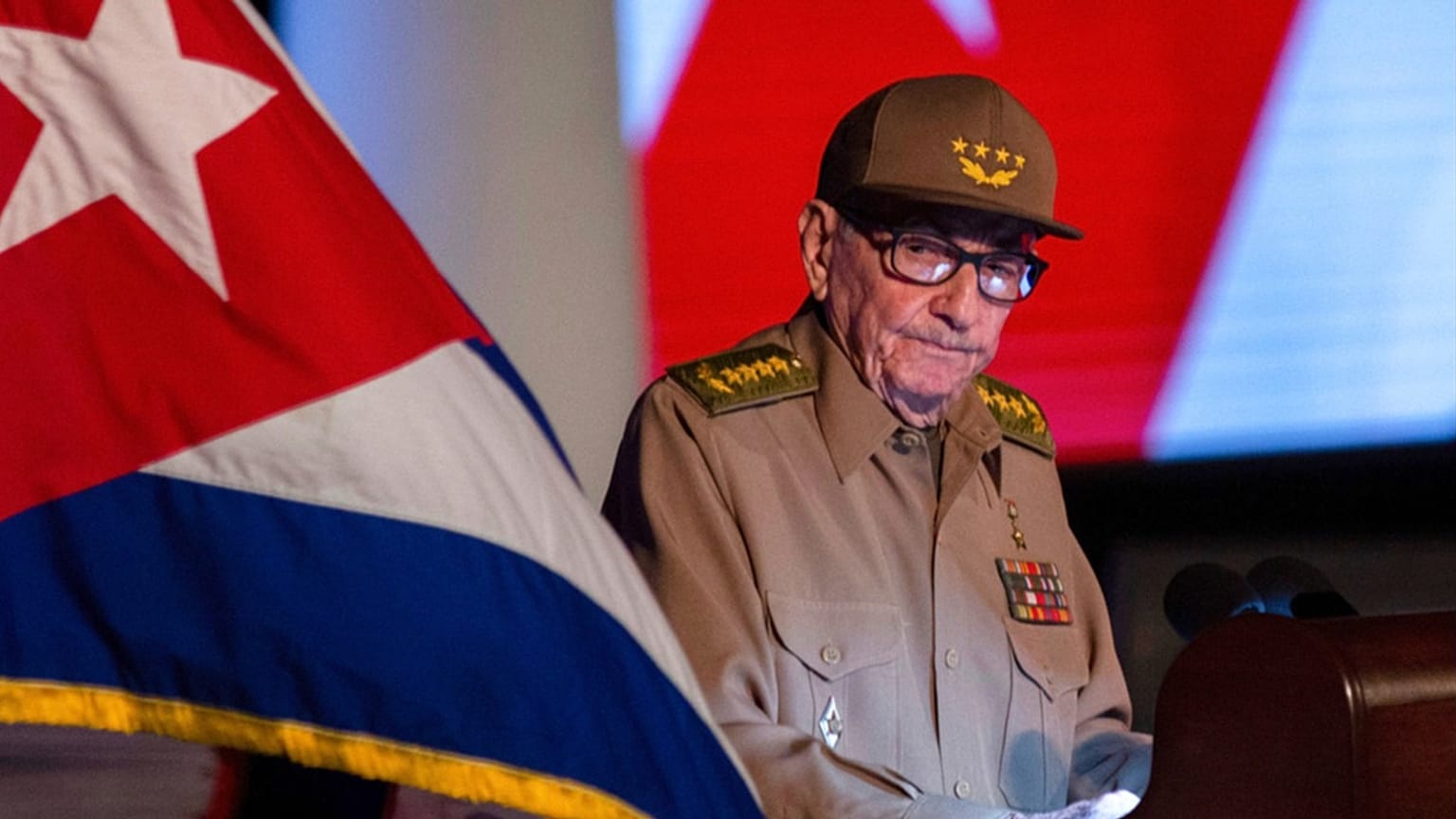 FILE - Former Cuban President Raul Castro looks at the Cuban flag during his speech at an event celebrating the 65th anniversary of the revolution, Cuba, Jan. 1, 2024