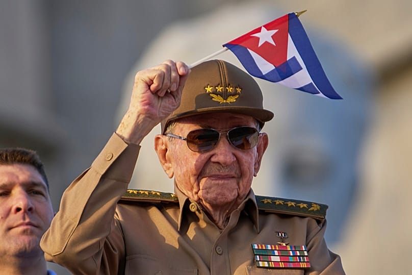 FILE - Raul Castro waves a Cuban national flag during a May Day parade at Revolution Square in Havana, May 1, 2025