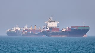 Container ships sit at anchor in the Strait of Hormuz off Bandar Abbas, Iran, Saturday, May 2, 2026.