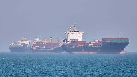 Container ships sit at anchor in the Strait of Hormuz off Bandar Abbas, Iran, Saturday, May 2, 2026.