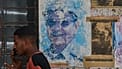 A man talks on the phone beside images of Raúl and Fidel Castro in Havana, Cuba, on Wednesday, 20 May 2026.