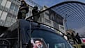 FILE: A poster of Ayatollah Mojtaba Khamenei is seen on an anti-riot police car as policemen stand on top during a rally to support him in Tehran, 9 March 2026