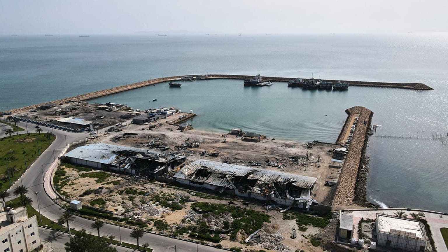 Backdropped by ships in the Strait of Hormuz, damage