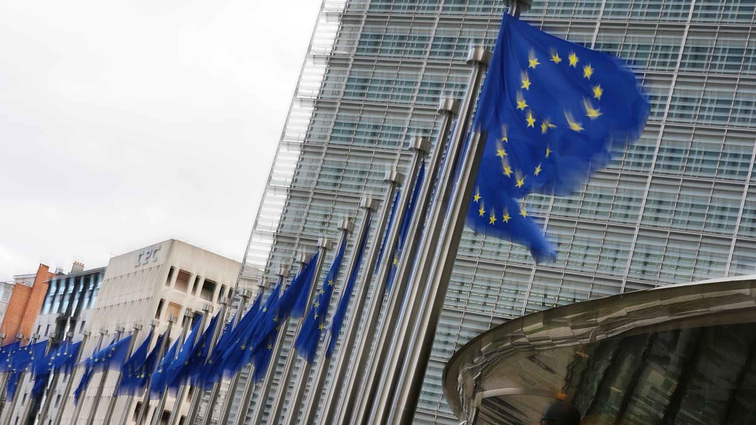 European Union flags flap in the wind outside EU headquarters in Brussels, Tuesday, May 12, 2026.