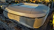 Toma aérea del Estadio Santiago Bernabéu en Madrid durante el atardecer mostrando su arquitectura moderna