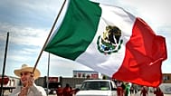 Severiano A. Rocillo waves a Mexican flag while walking in the annual Cinco de Mayo parade Saturday, 5 May, 2007.