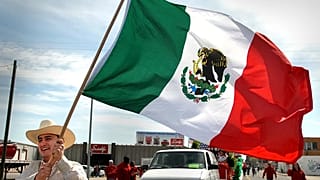 Severiano A. Rocillo waves a Mexican flag while walking in the annual Cinco de Mayo parade Saturday, 5 May, 2007.