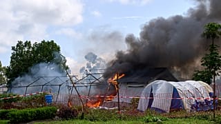 Flames and smoke rise from an Ebola treatment center in Rwampara, Congo, Thursday, May 21, 2026.