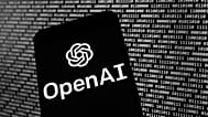 FILE - The OpenAI logo appears on a mobile phone in front of a computer screen with random binary data, March 9, 2023, in Boston. 