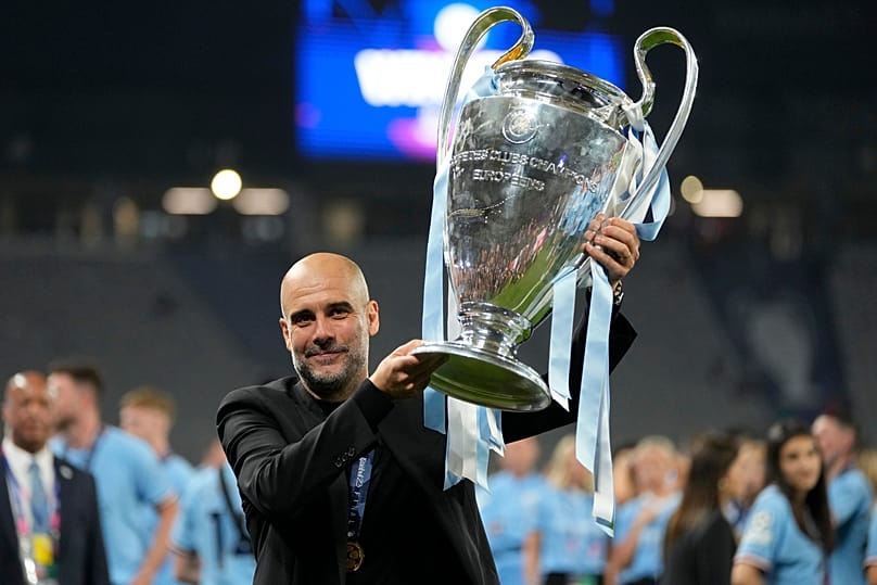 Manchester City's head coach Pep Guardiola holds the trophy after winning the Champions League final between Manchester City and Inter Milan in Istanbul, 11 June, 2023