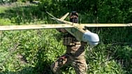 A Ukrainian serviceman of Khartia brigade launches a drone towards Russian positions at the front line in the Kharkiv region, Ukraine, Wednesday, May 20, 2026.