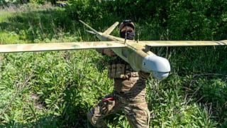 A Ukrainian serviceman of Khartia brigade launches a drone towards Russian positions at the front line in the Kharkiv region, Ukraine, Wednesday, May 20, 2026.