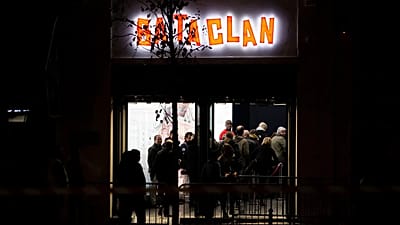 People enter the Bataclan concert hall in Paris, Saturday, Nov. 12, 2016. 