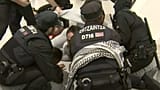 Ertzaintza officers charge at activists at Bilbao airport, Spain, on 23 April 2026.