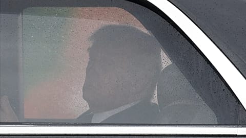 President Donald Trump looks toward Air Force One from his limousine known as "The Beast," upon his arrival at Joint Base Andrews, Md., Friday, May 22, 2026.