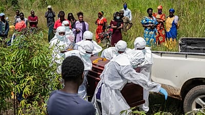 Red Cross workers prepare a coffin containing the body of the Ebola victim for burial at the Rwampara Cemetery, in Bunia, Congo, Saturday, May 23, 2026.