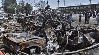 Police officers and local residents examine damages at the site of bomb explosion, in Quetta, Pakistan, Sunday, May 24, 2026.