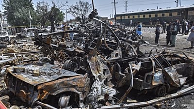 Police officers and local residents examine damages at the site of bomb explosion, in Quetta, Pakistan, Sunday, May 24, 2026.
