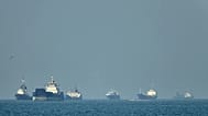 Cargo ships sit at anchor offshore in the Strait of Hormuz off Bandar Abbas, 4 May, 2026