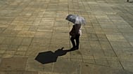 Una donna si ripara dal sole con un ombrello in una calda giornata estiva a Pamplona, nel nord della Spagna.