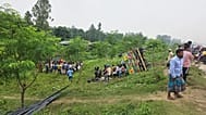 People look on after a truck carrying iron rods and extra passengers overturned on a highway in central district of Tangail, 25 May, 2026
