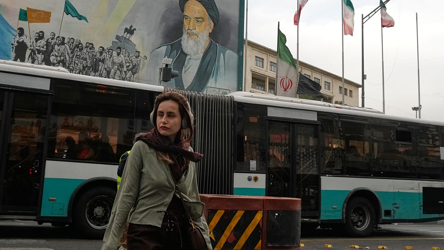 امرأة تعبر شارعًا أمام لوحة لآية الله الخميني في وسط طهران، الأحد 24 أيار/مايو 2026.