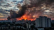 Smoke raises above the city in sunrise following an intensive Russian air attack in Kyiv, 24 May, 2026