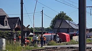 Rescue workers on the scene of a crash between a train and vehicle in Buggenhout, 26 May, 2026