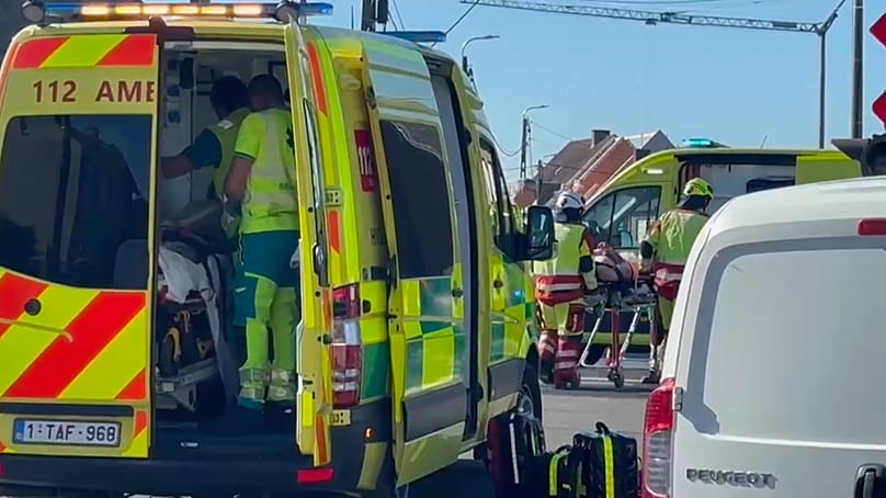 This video grab shows rescue workers on the scene of a crash between a train and vehicle in Buggenhout, 26 May, 2026