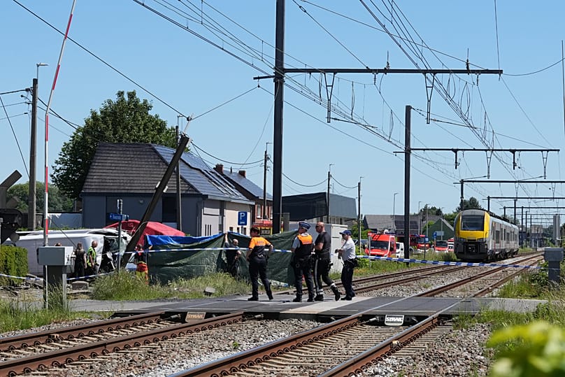 Rescue workers on the scene of a crash between a train and vehicle in Buggenhout, 26 May, 2026