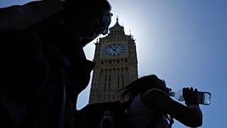 A woman drinks water in temperatures of up to 30 degrees at the Elizabeth Tower, commonly known as Big Ben in London, Tuesday, May 26, 2026.