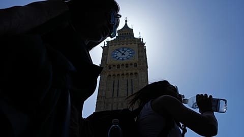 A woman drinks water in temperatures of up to 30 degrees at the Elizabeth Tower, commonly known as Big Ben in London, Tuesday, May 26, 2026.