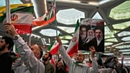A man holds a sign depicting current Supreme Leader Ayatollah Mojtaba Khamenei at the Imam Khomeini Grand Mosque in Tehran, 24 May 2026
