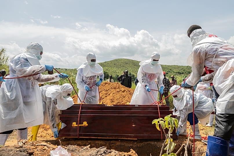 Red Cross workers bury an Ebola victim at the Rwampara Cemetery, in Rwampara, Congo, Saturday, May 23, 2026. 