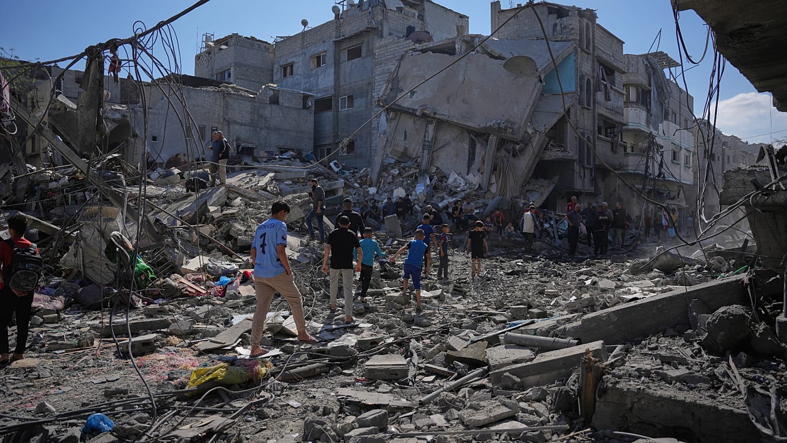 Palestinians inspect the rubble of a building destroyed in an Israeli airstrike in Nuseirat, central Gaza Strip, Tuesday, May 26, 2026.
