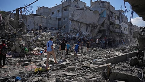 Palestinians inspect the rubble of a building destroyed in an Israeli airstrike in Nuseirat, central Gaza Strip, Tuesday, May 26, 2026.