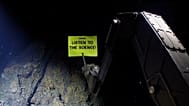 Greenpeace banner reading 'Listen To The Science' from 2,300 meters below the surface
