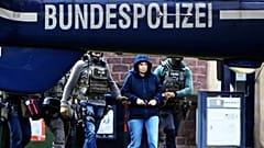 Former RAF member Daniela Klette is led to a helicopter in the courtyard of a government centre in Karlsruhe, 7 March, 2024