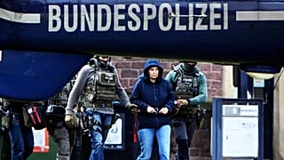 Former RAF member Daniela Klette is led to a helicopter in the courtyard of a government centre in Karlsruhe, 7 March, 2024